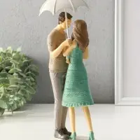 Сувенир полистоун "Папа, мама и малыш в вязанных нарядах, под зонтом" 8,5х9,5х25,5 см